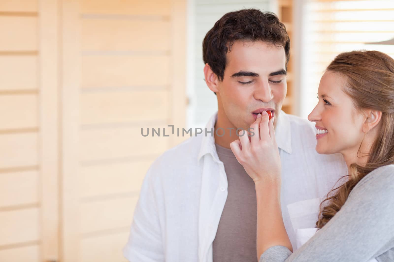 Young woman feeding her boyfriend