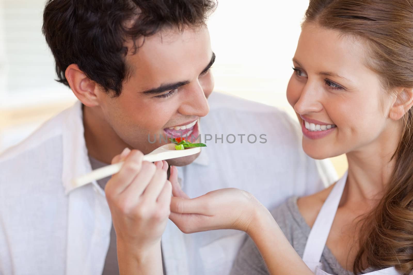 Happy smiling couple enjoys cooking together