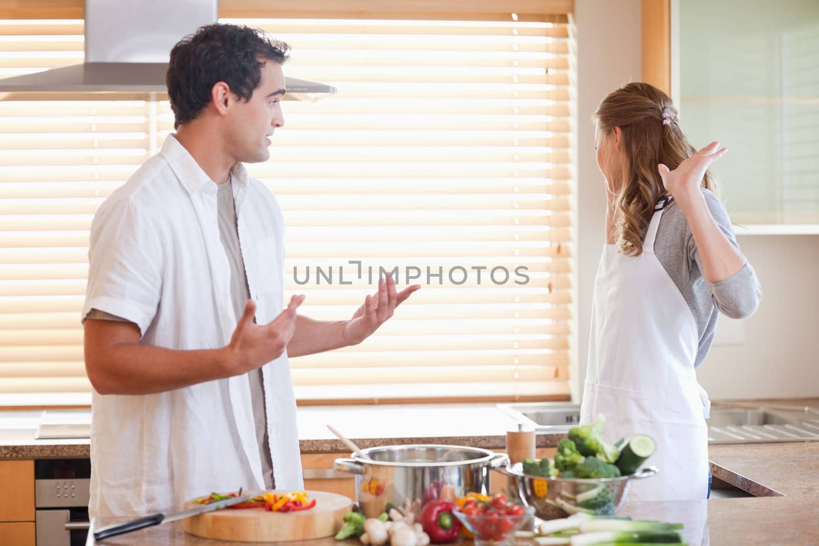 Young couple has a tensed situation in the kitchen