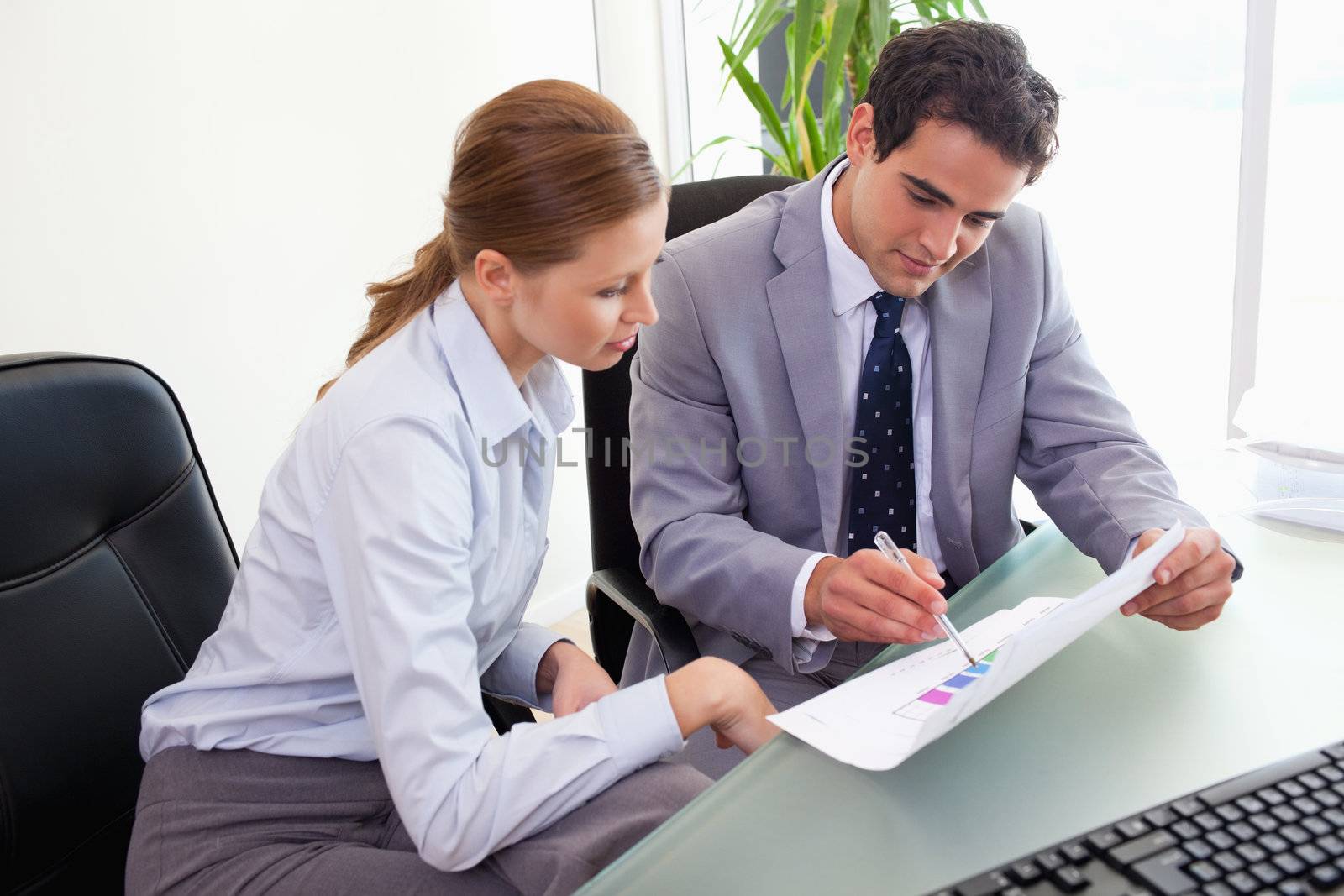 Young colleagues analyzing statistics together