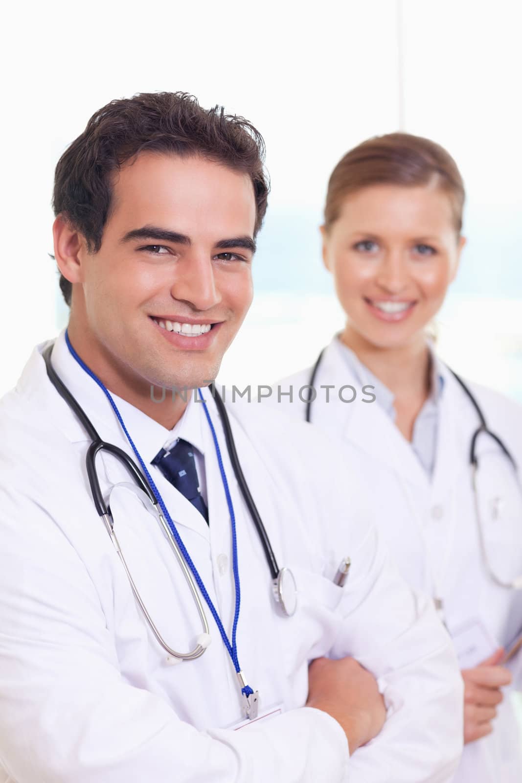 Smiling young medical team standing next to each other