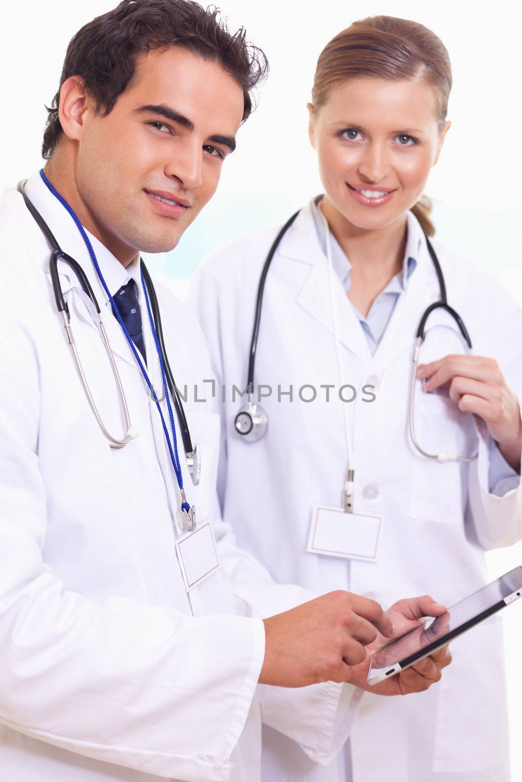 Young assistant doctors with tablet