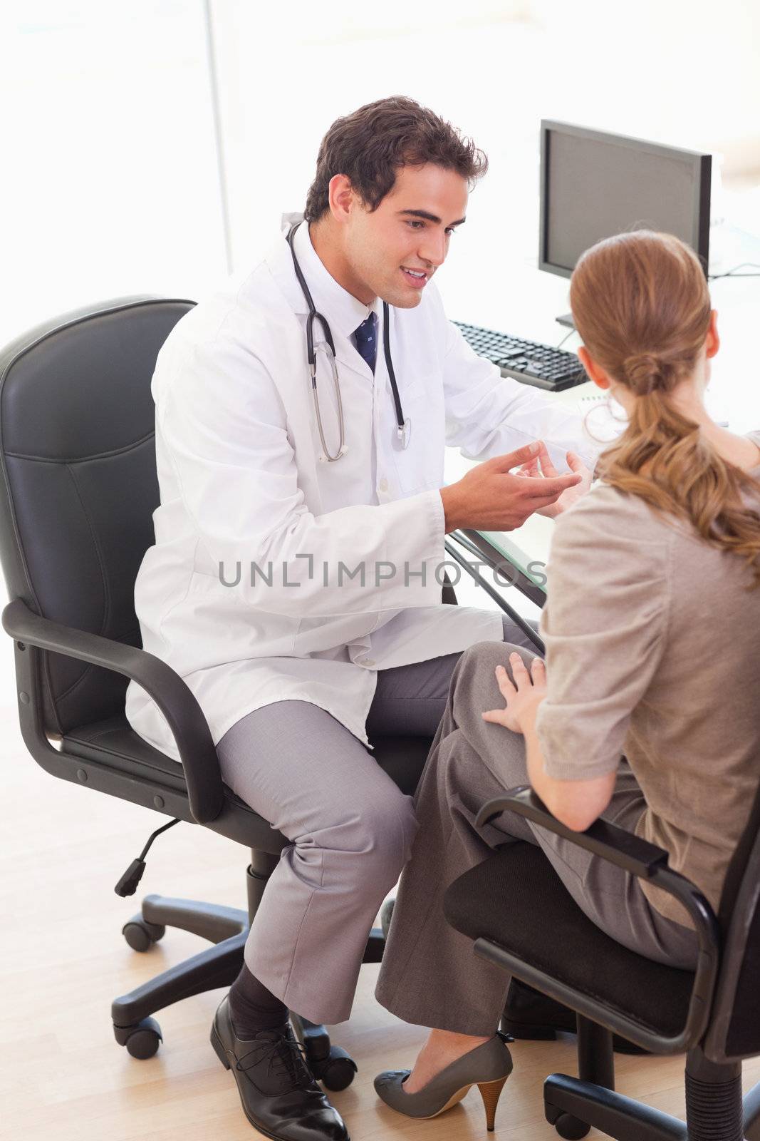 Young doctor talking with his patient