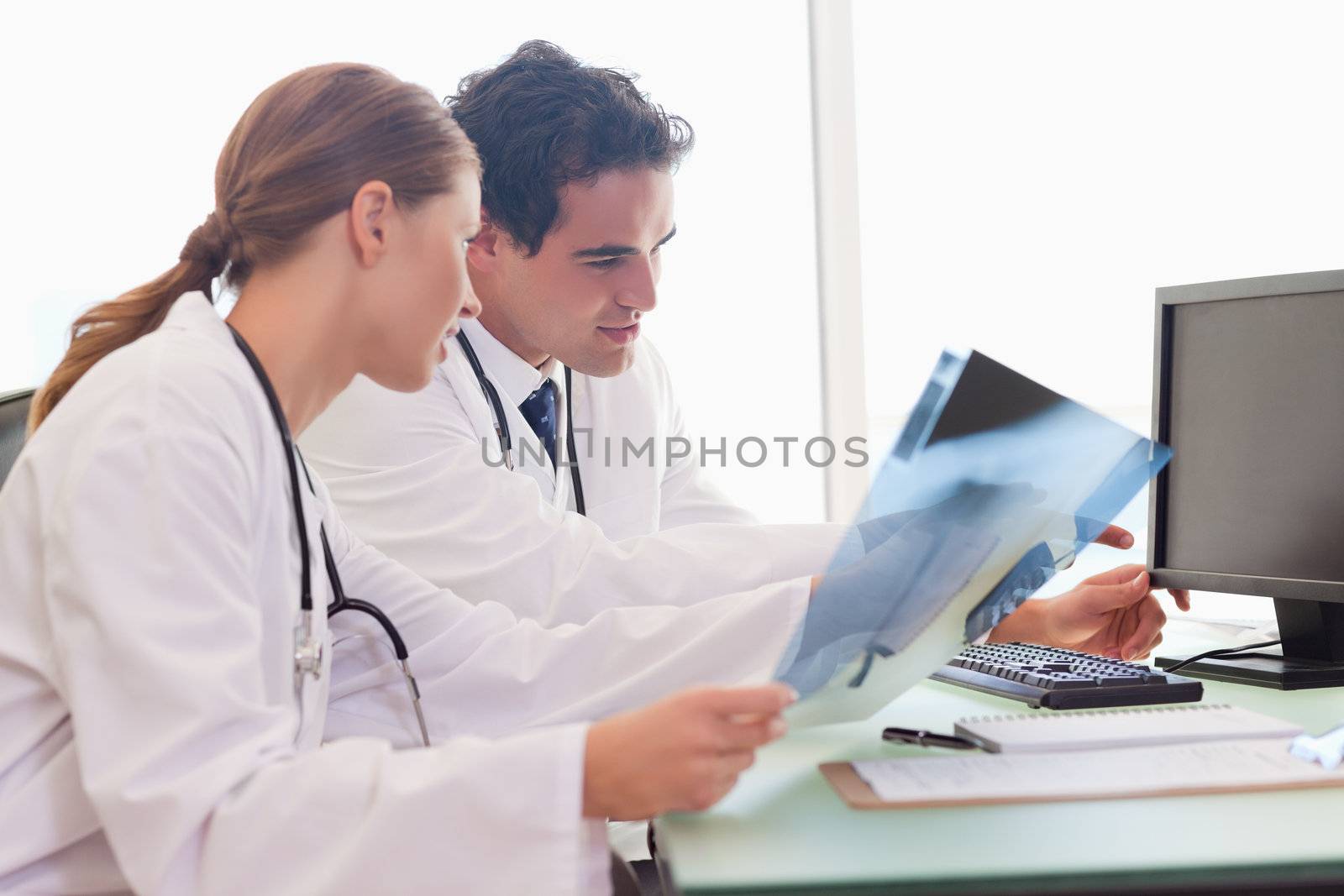 Young medical team analyzing x-rays