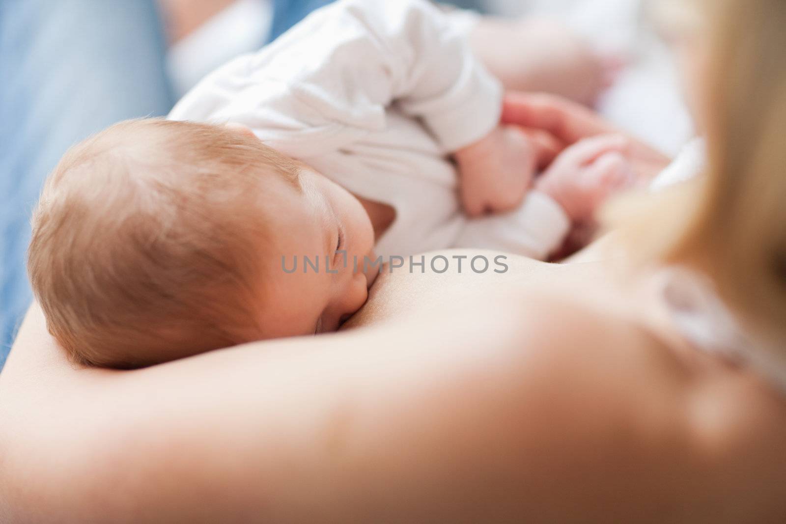 Small newborn getting suckled