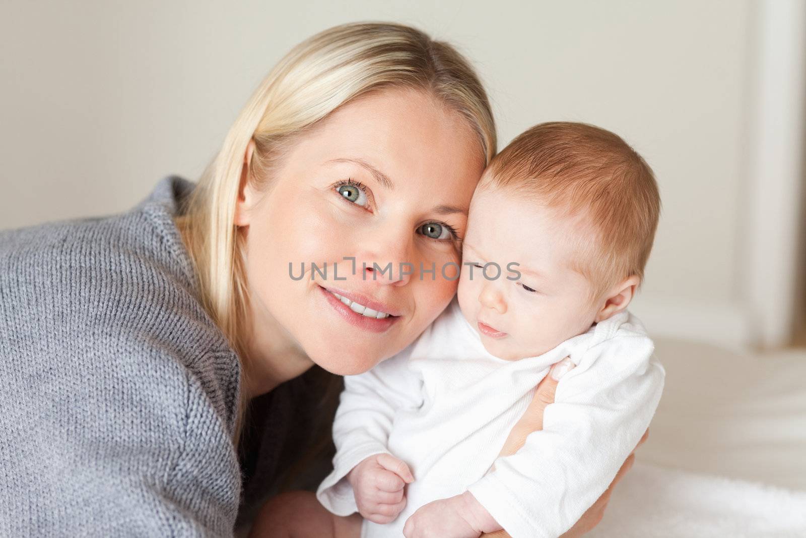 Young mother holding her newborn close