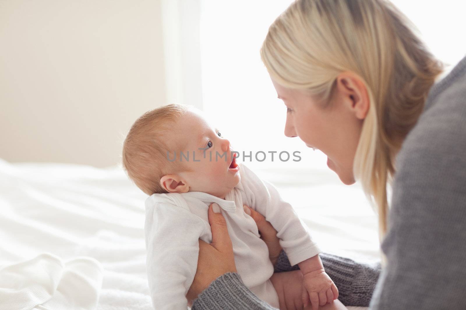 Affectionate young mom holding her newborn