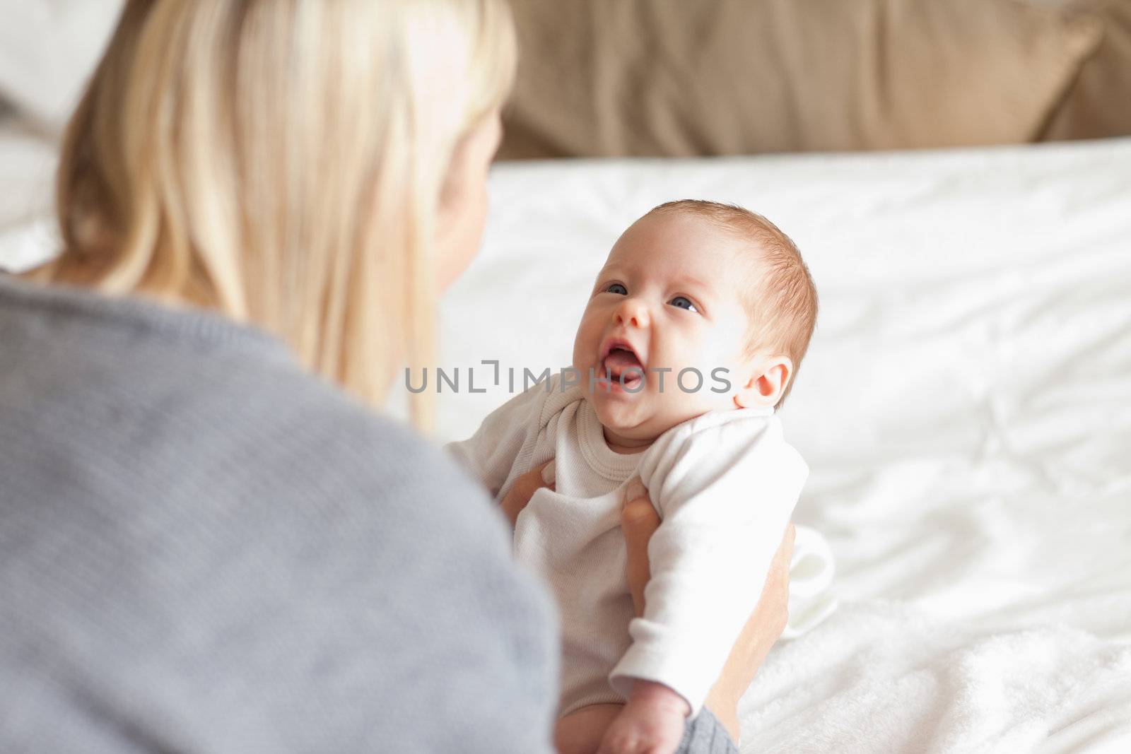 Young mother laying down her newborn