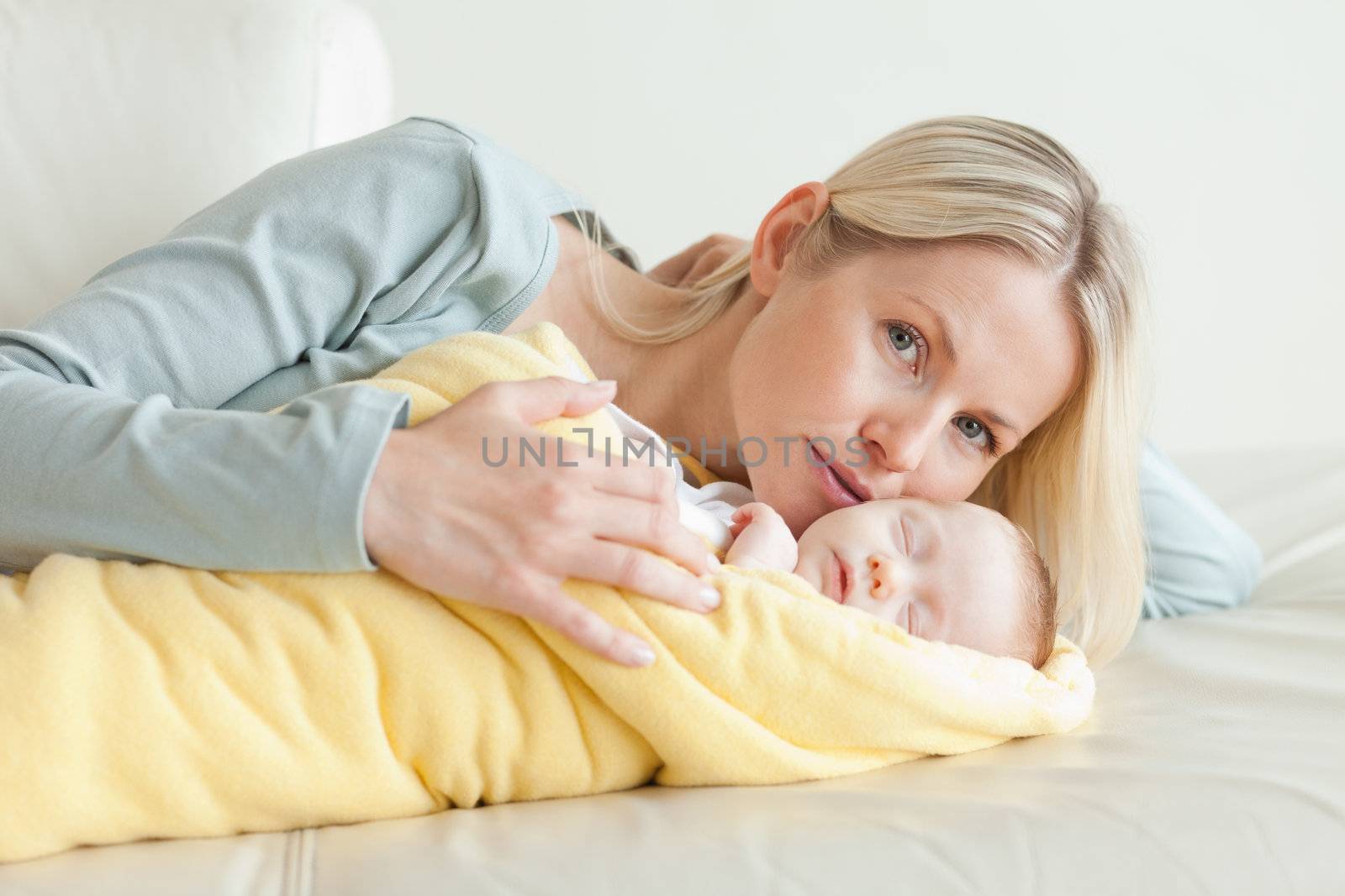 Young mom relaxing next to her baby