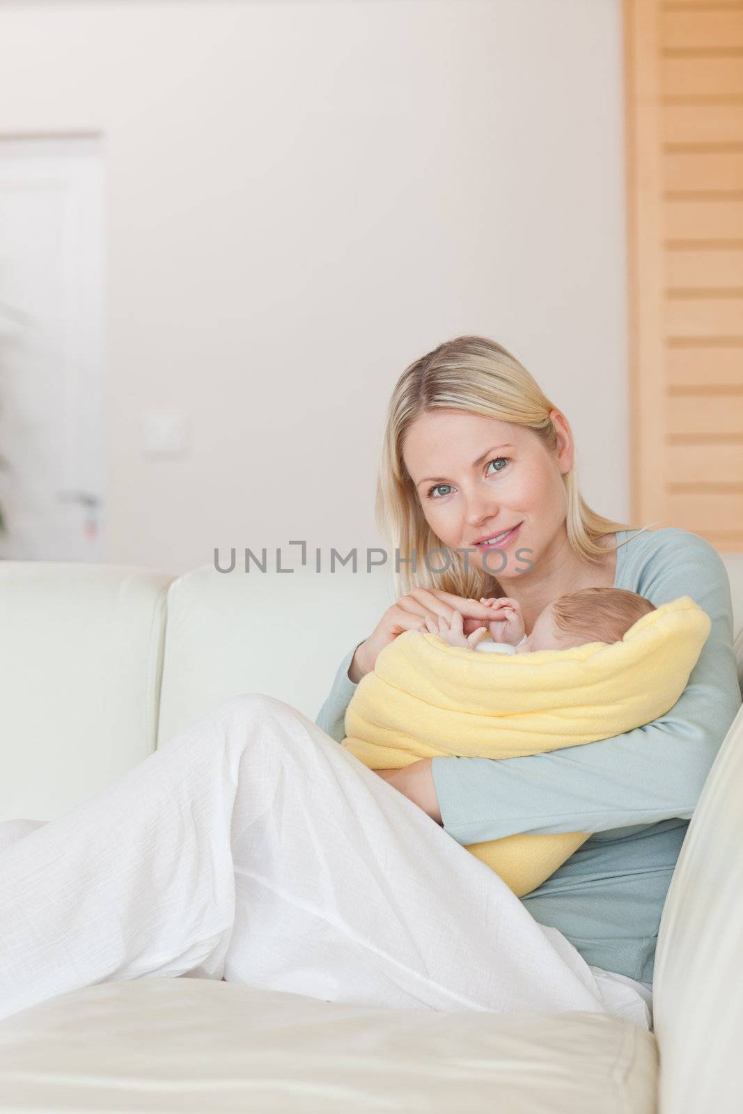 Baby reaching for it's young mothers finger