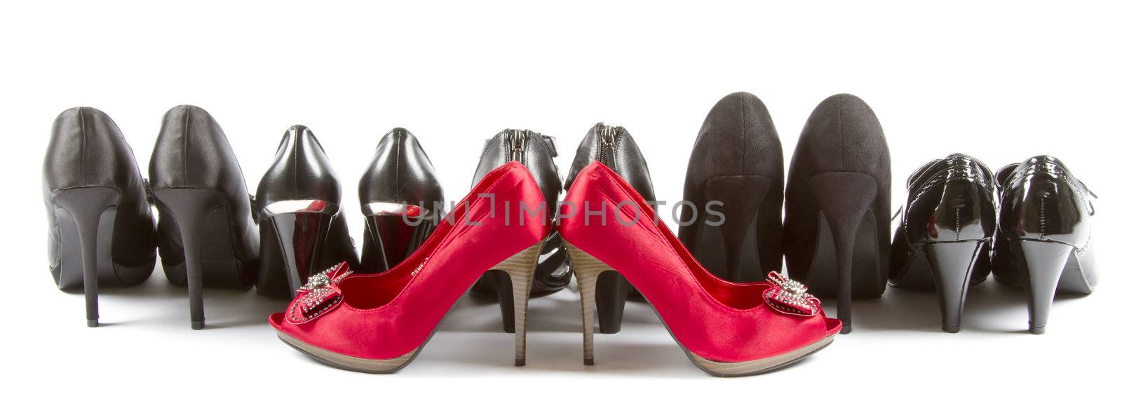 Several pairs of high heels in red and black