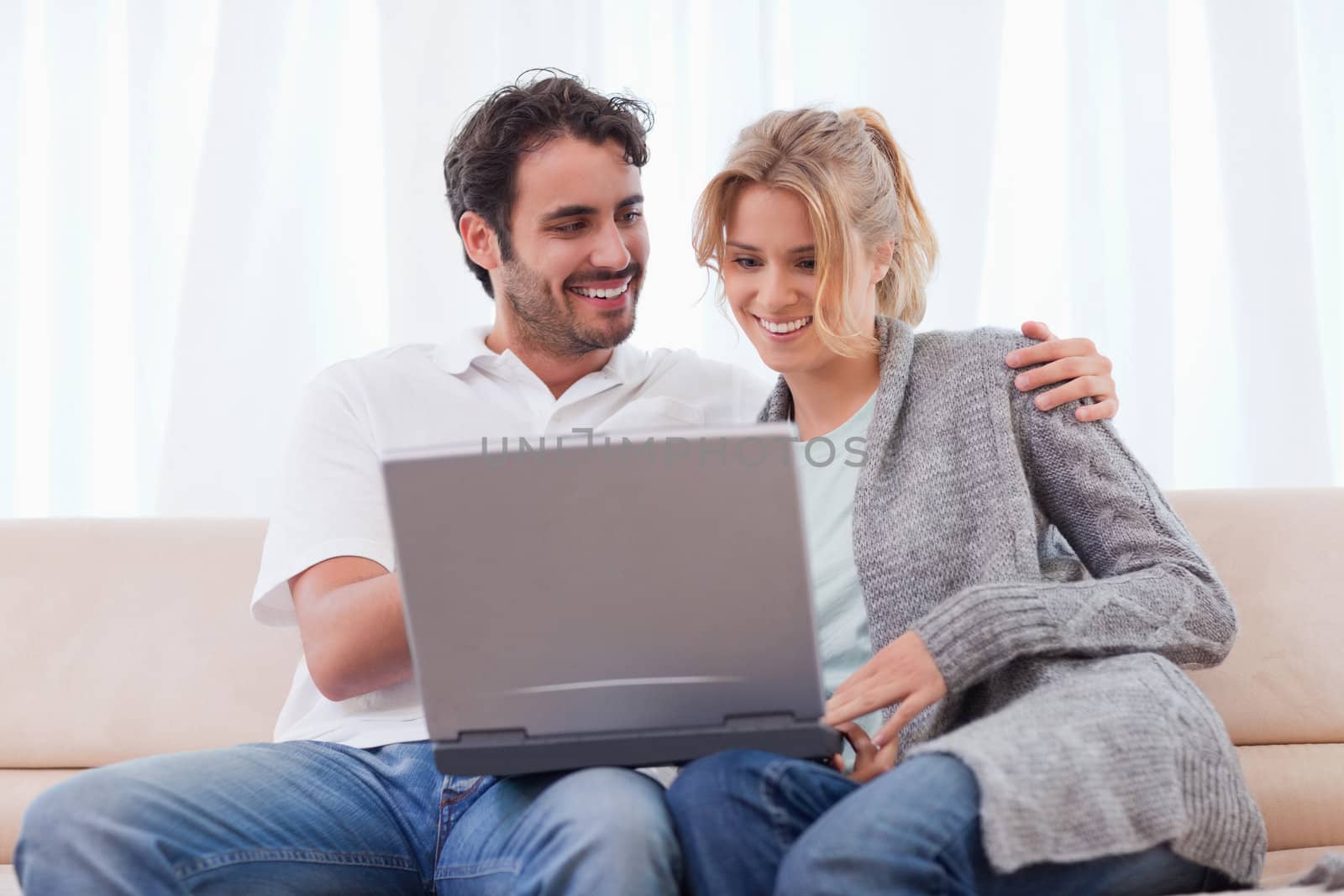 Couple using a notebook in their living room
