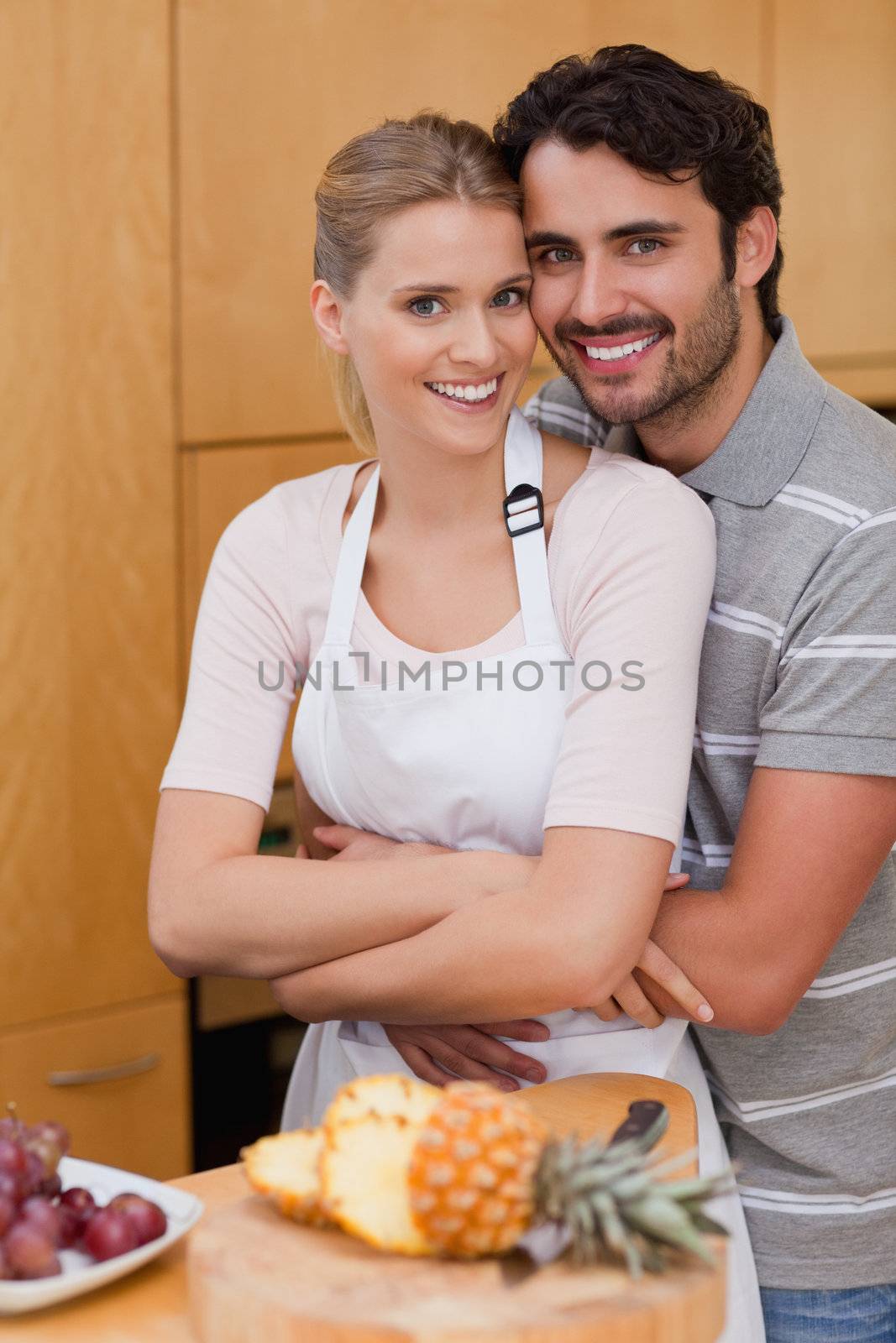 Portrait of a posing with fruits in their kitchen