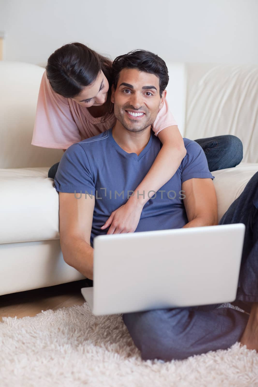 Portrait of a lovely couple using a notebook in their living room