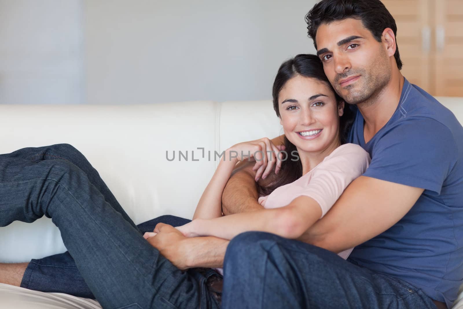 Lovely young couple posing in their living room