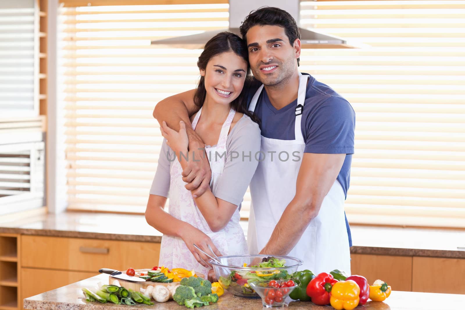 Charming young couple posing in their kitchen