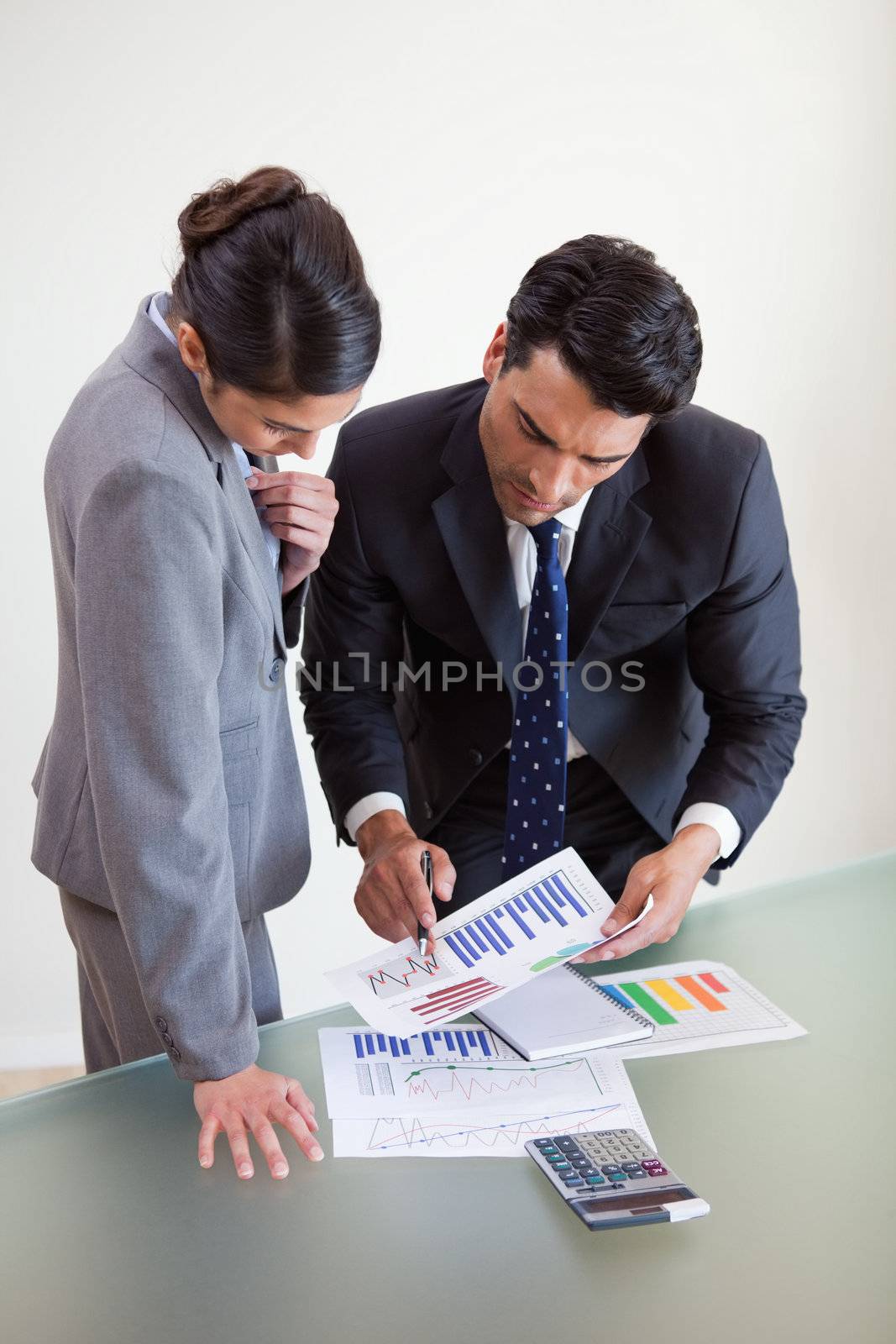 Portrait of focused sales persons studying statistics in an office