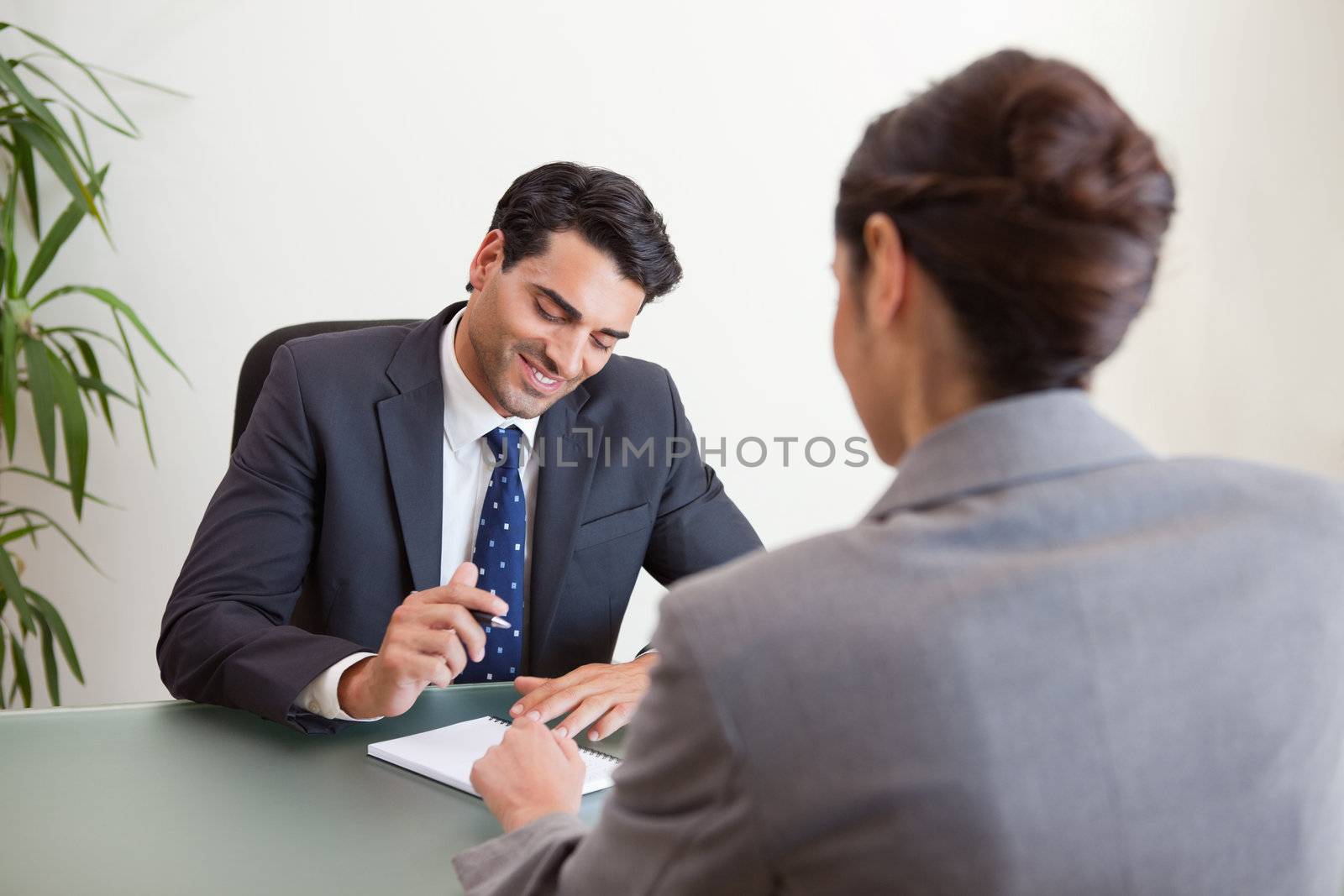 Manager interviewing a female applicant in his office