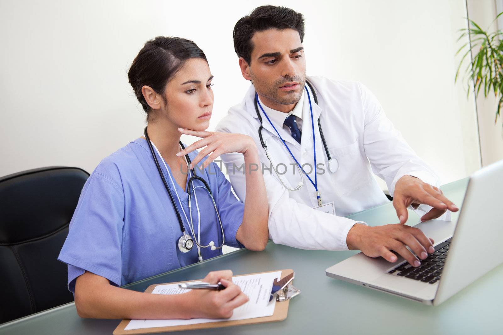 Young doctors working with a notebook in an office