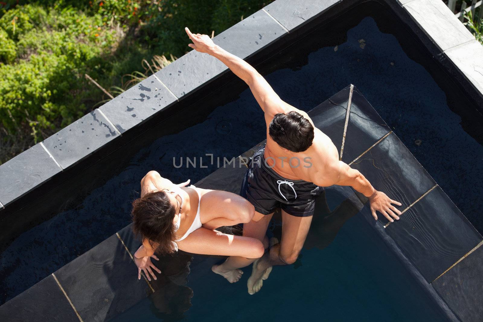 Above view of a young couple talking in a swimming pool