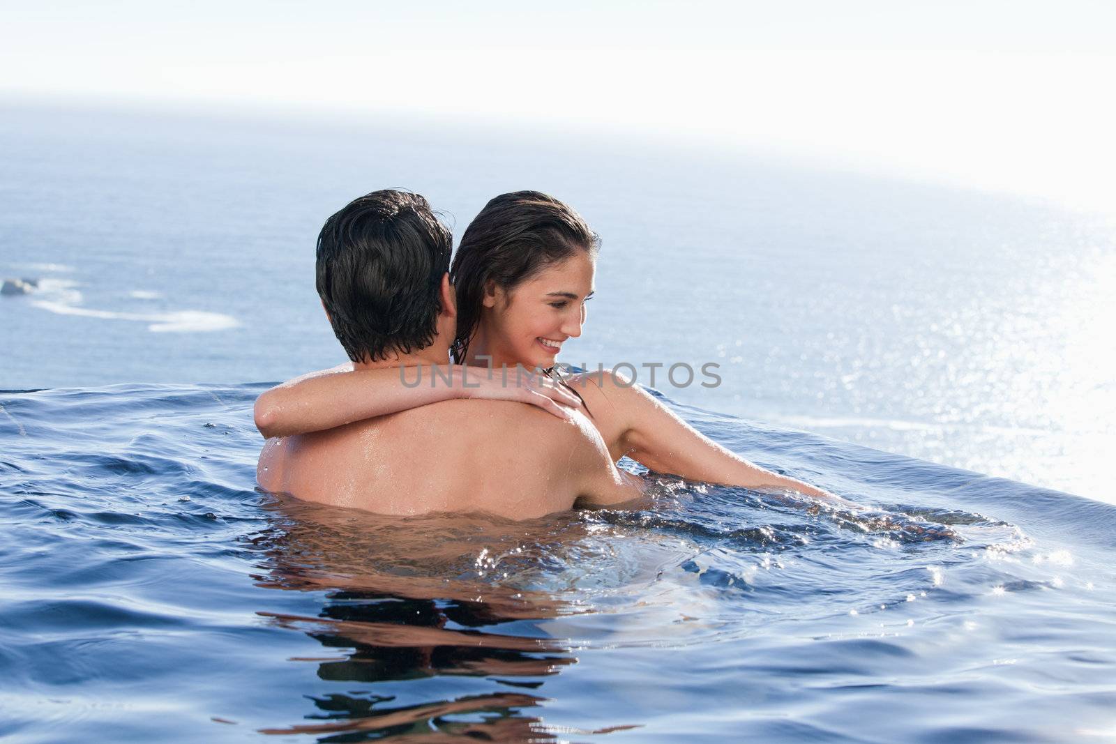 Smiling couple playing together in a swimming pool