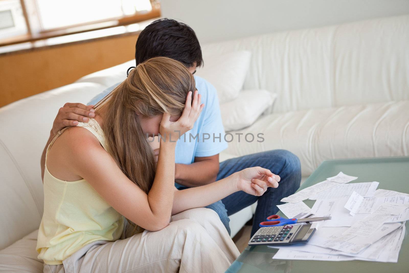 Sad couple in financial trouble in their living room