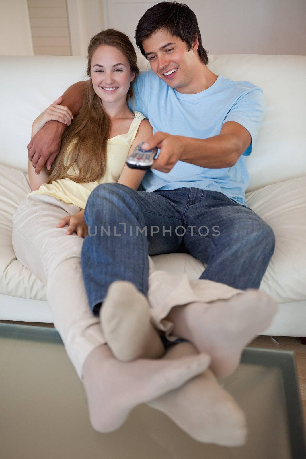 Portrait of a relaxed couple watching television in their living room