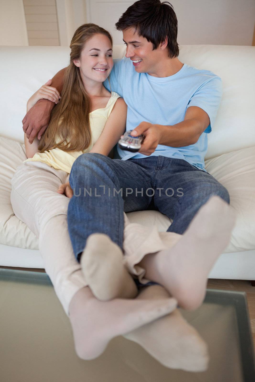 Portrait of a lovely couple watching television in their living room