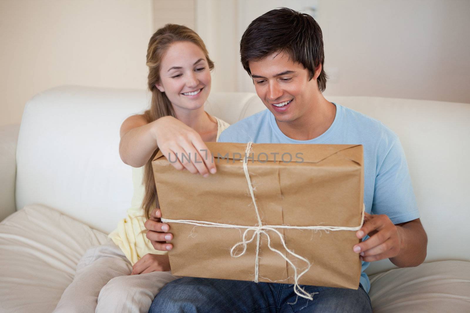 Couple opening a package in their living room