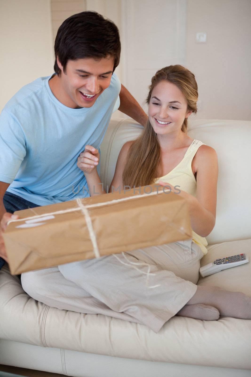 Portrait of a couple looking at a package in their living room