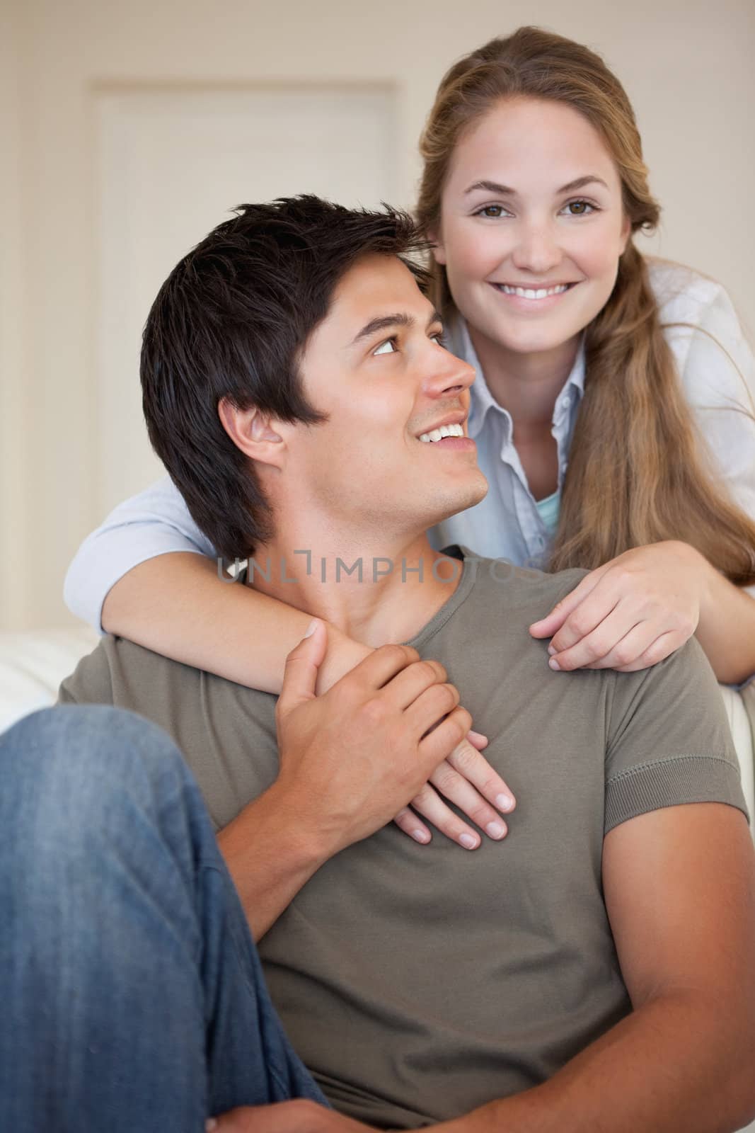 Portrait of a couple embracing each other in their living room
