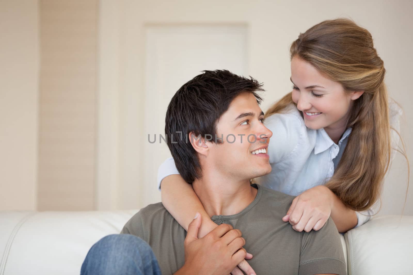 Lovely couple hugging in their living room