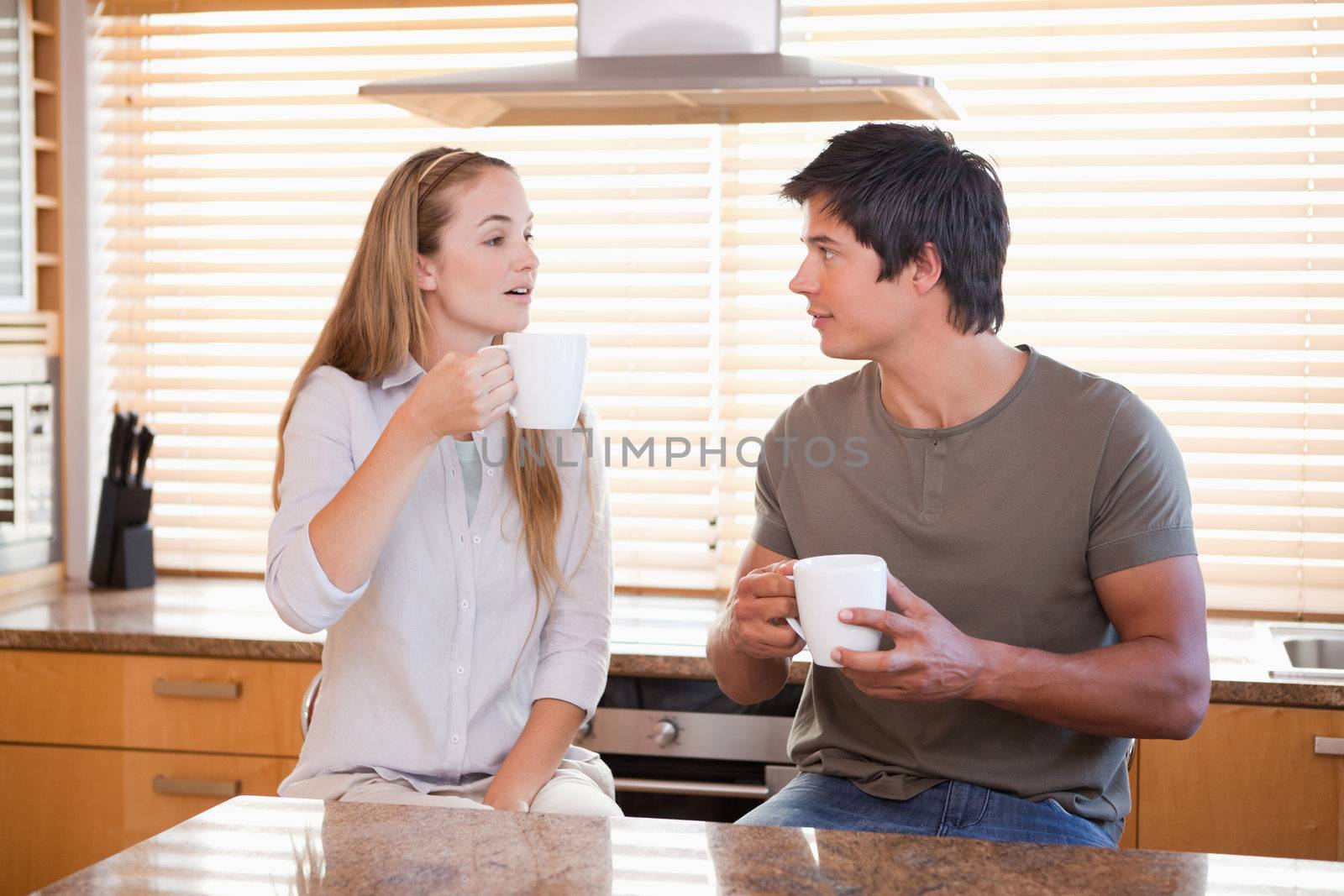 Couple having a cup of tea in their kitchen