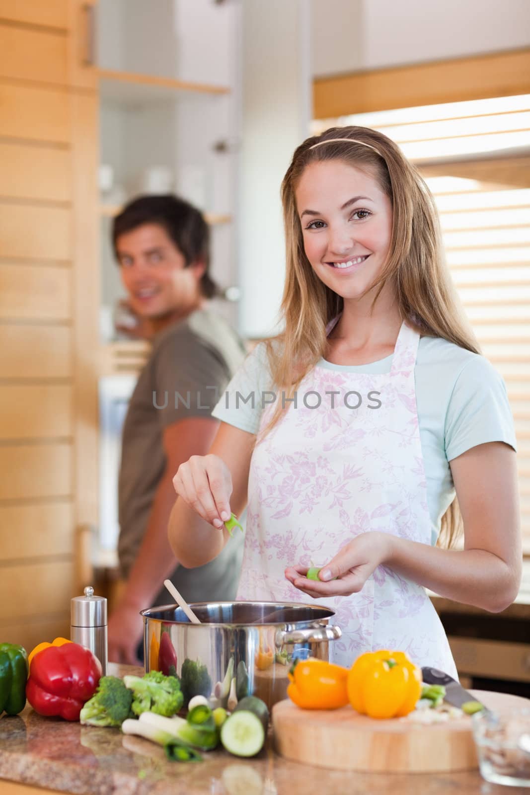 Portrait of a smiling couple cooking in their kitchen