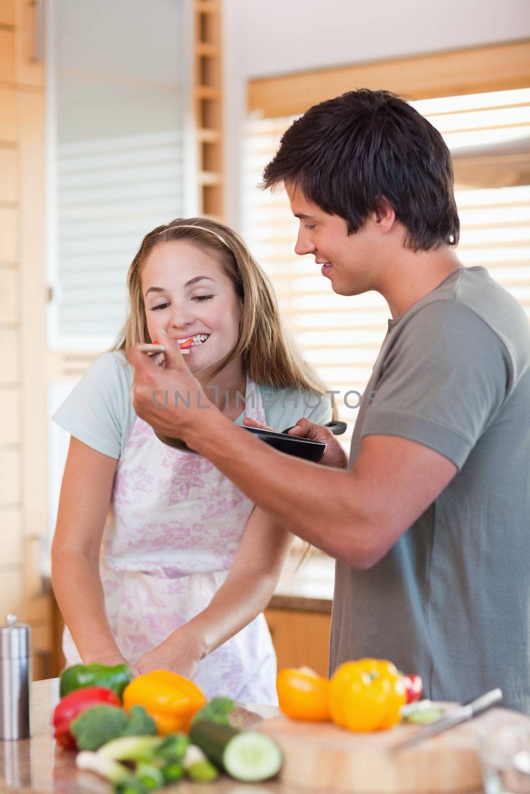 Portrait of a young couple preparing dinner in their kitchen