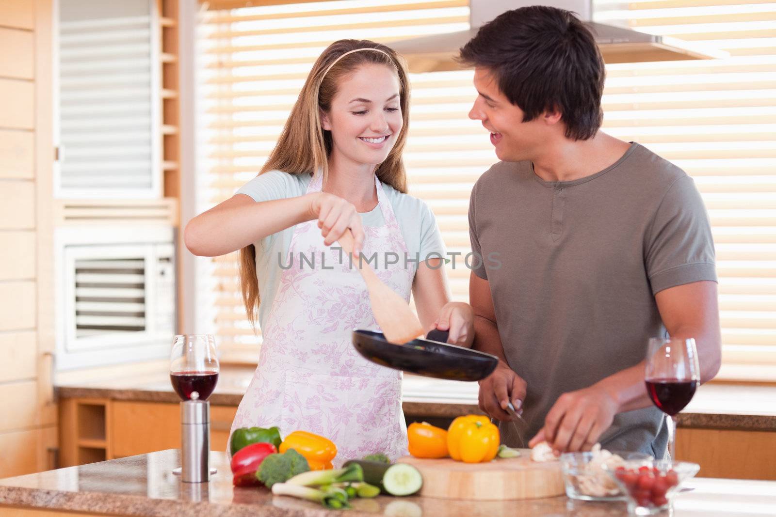 Couple cooking dinner in their kitchen