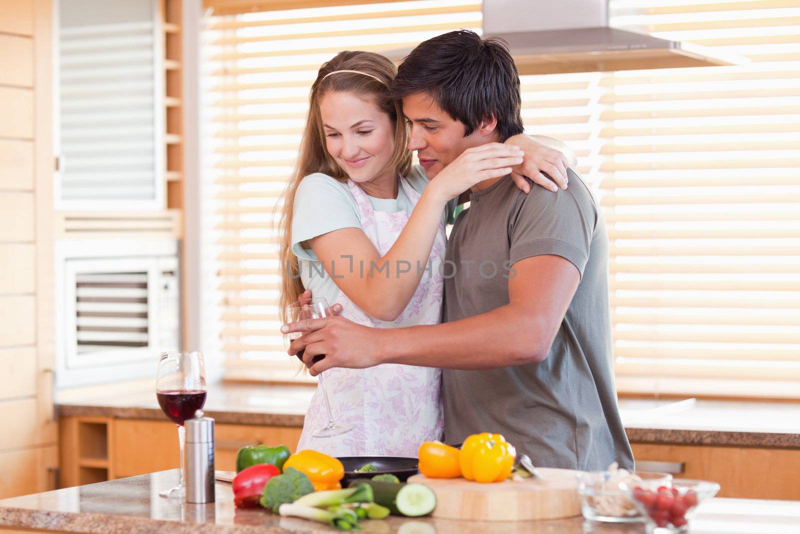 Couple drinking wine in their kitchen