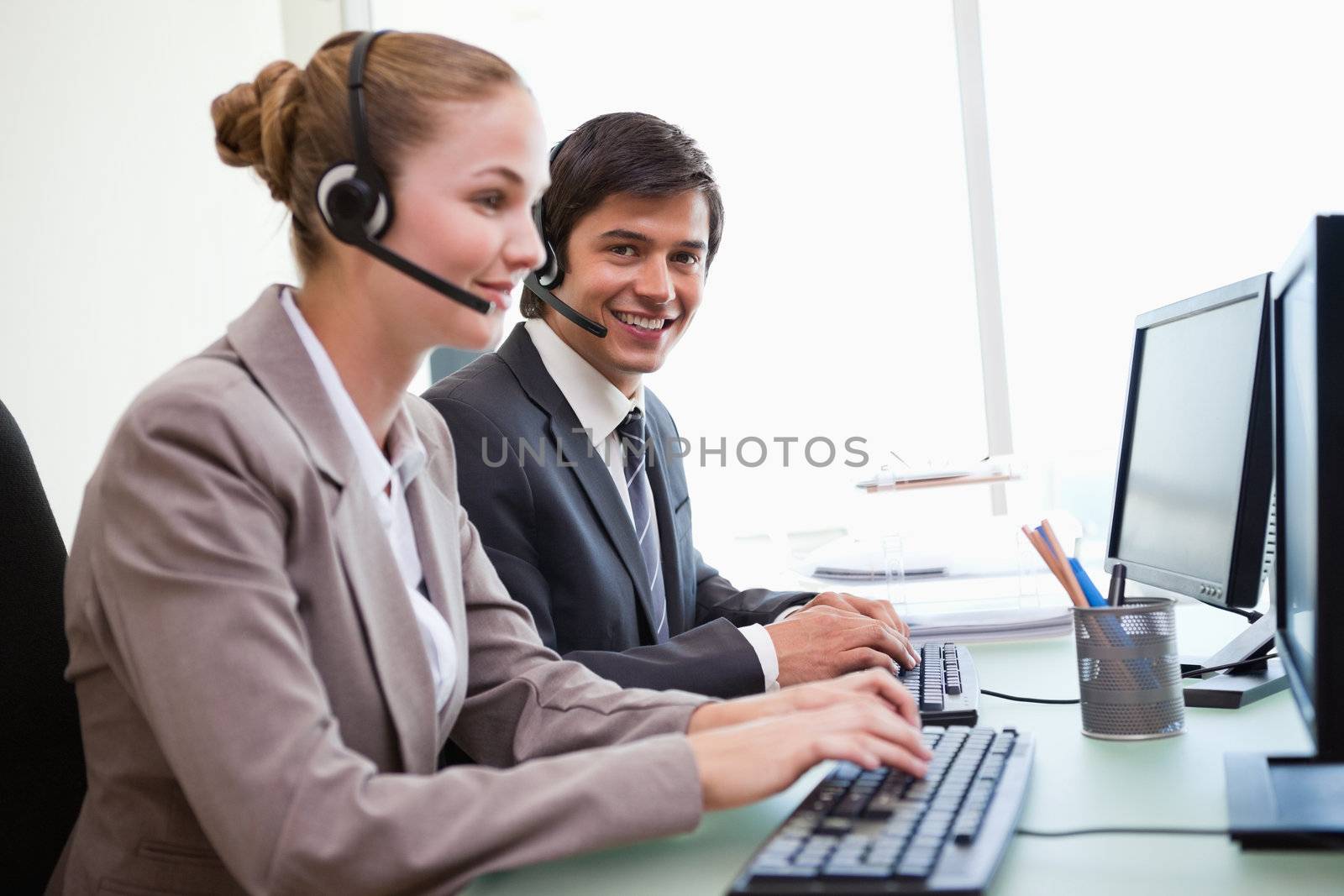 Office workers using computers in an office