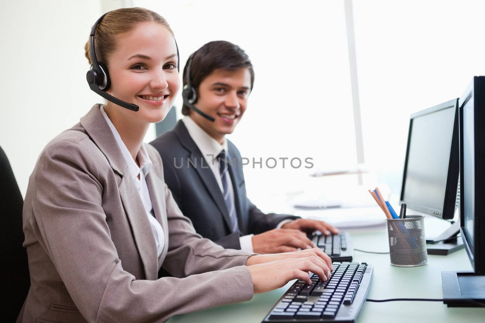 Young office workers using computers in an office