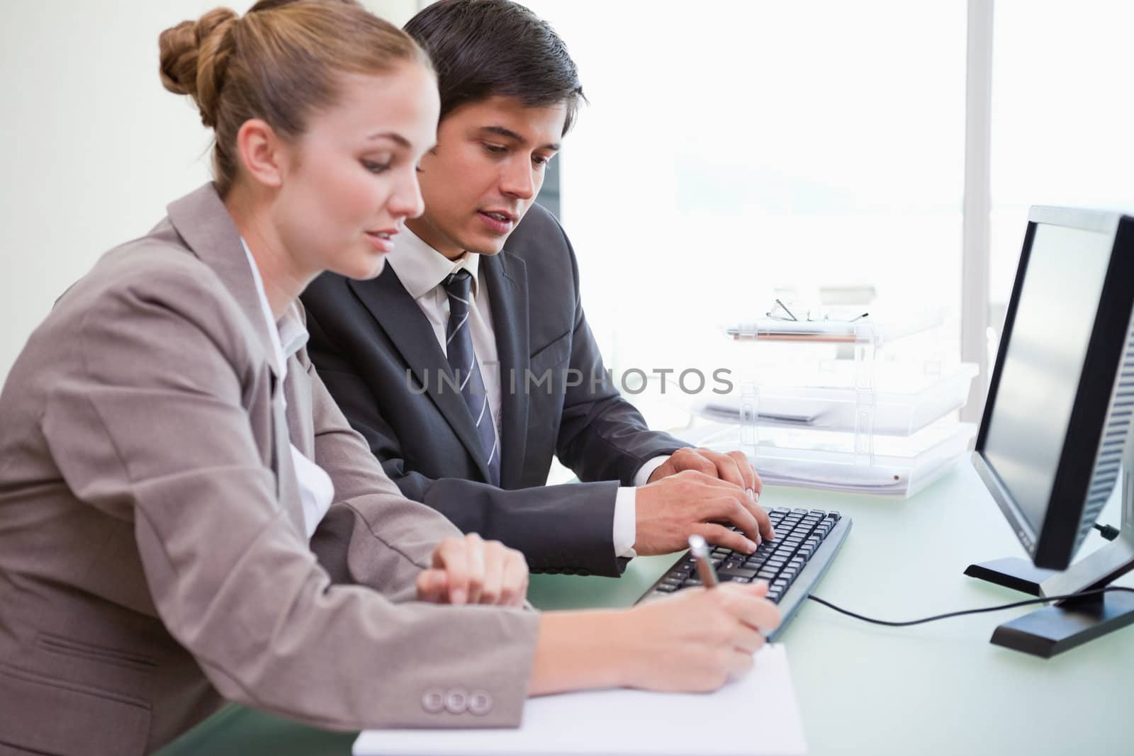 Young business people working with a computer in an office