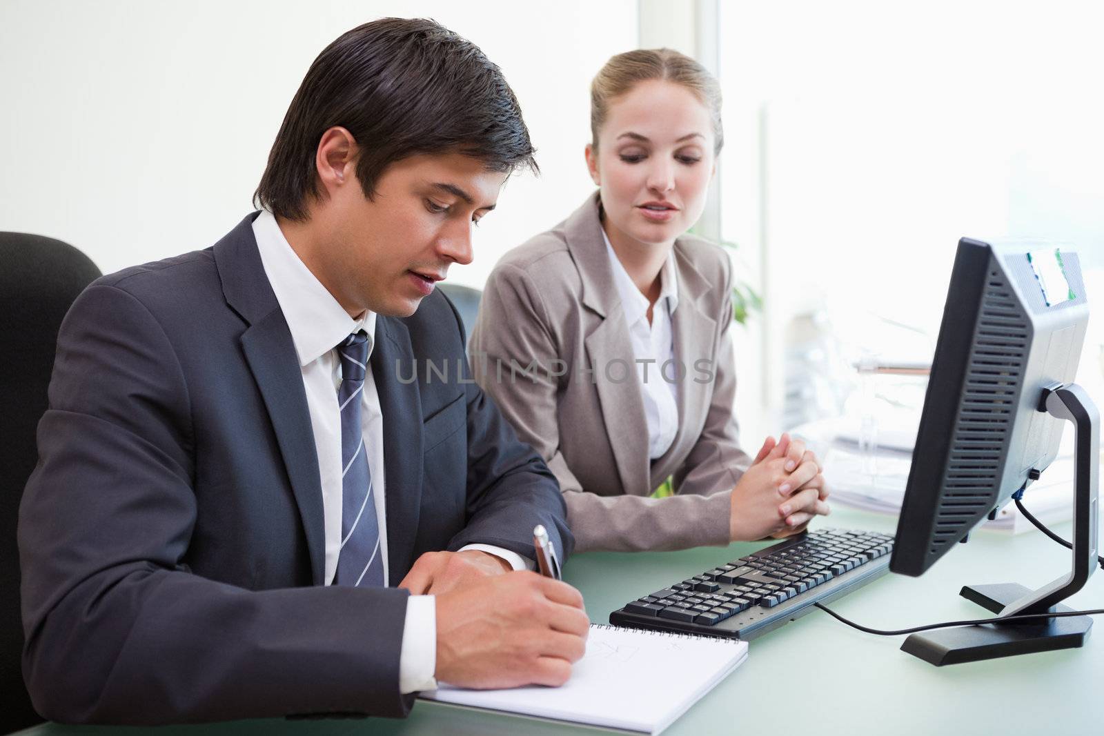 Serious business people working with a computer in an office