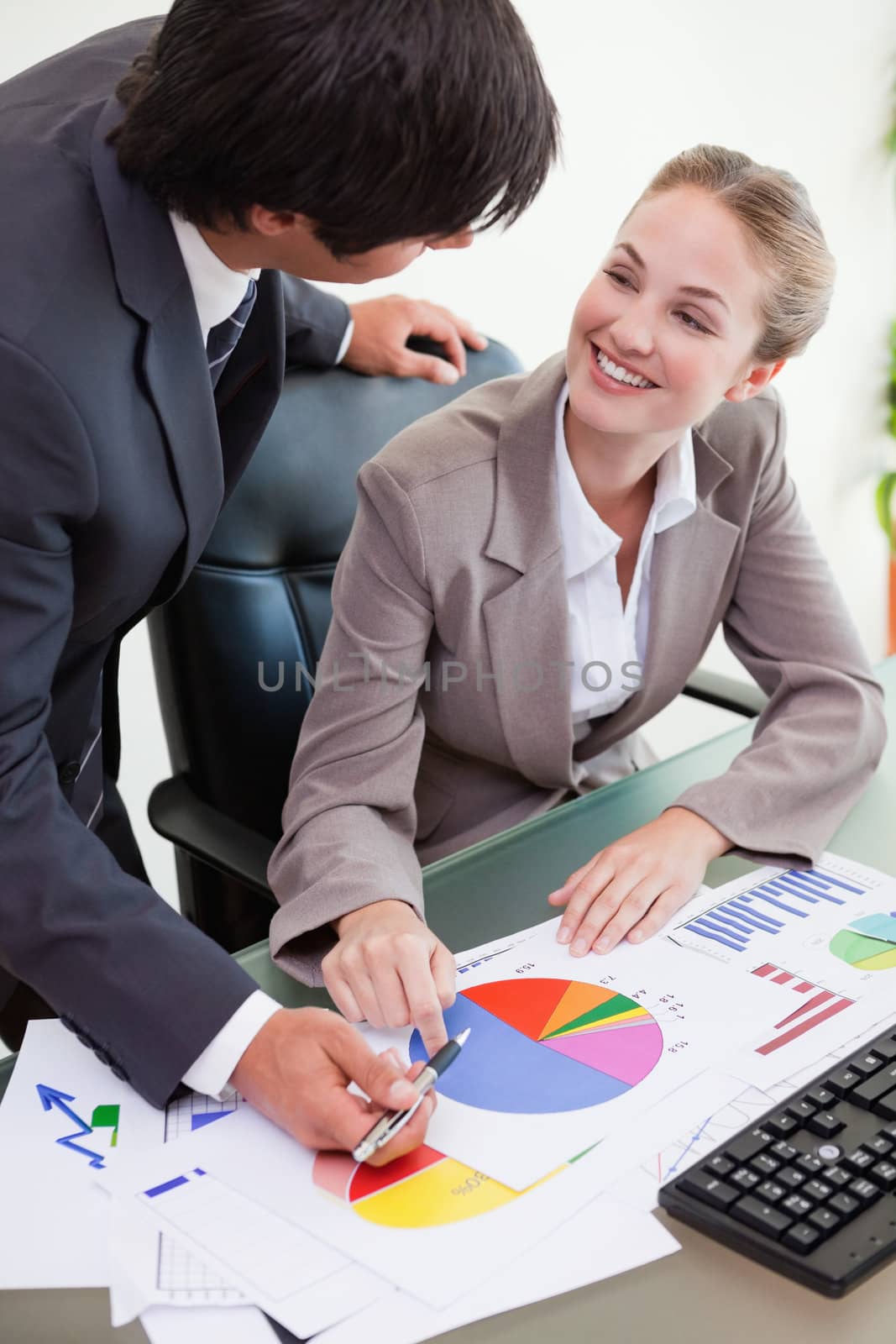 Portrait of a young business team studying statistics in a meeting room