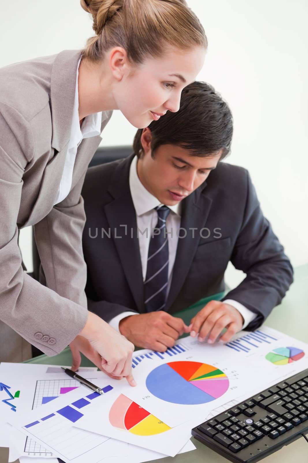 Portrait of a serious business team studying statistics with a computer in a meeting room