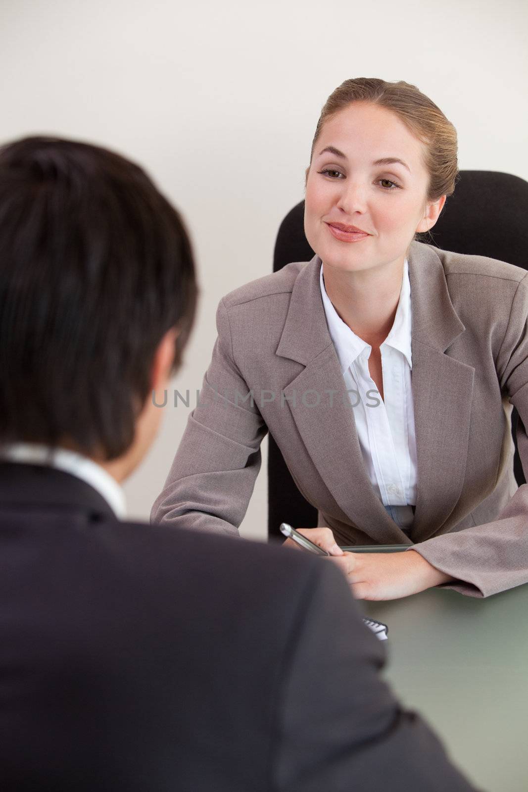 Portrait of a manager interviewing a male applicant in her office