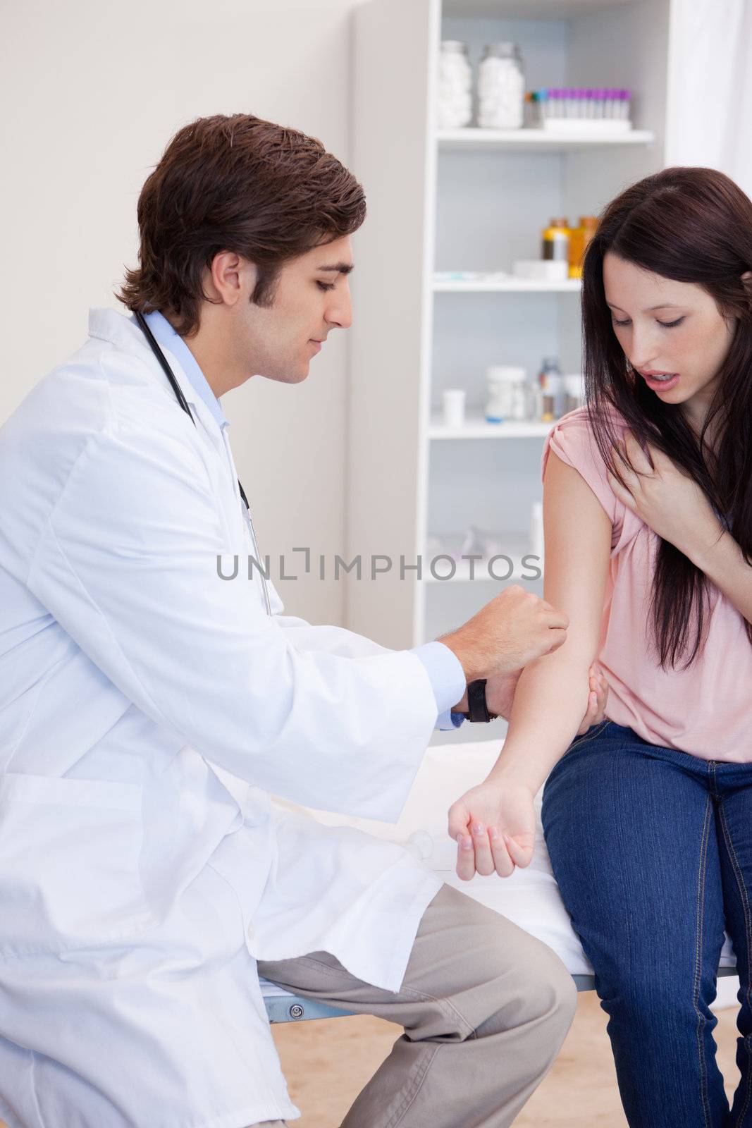 Male doctor prepares patients arm for injection