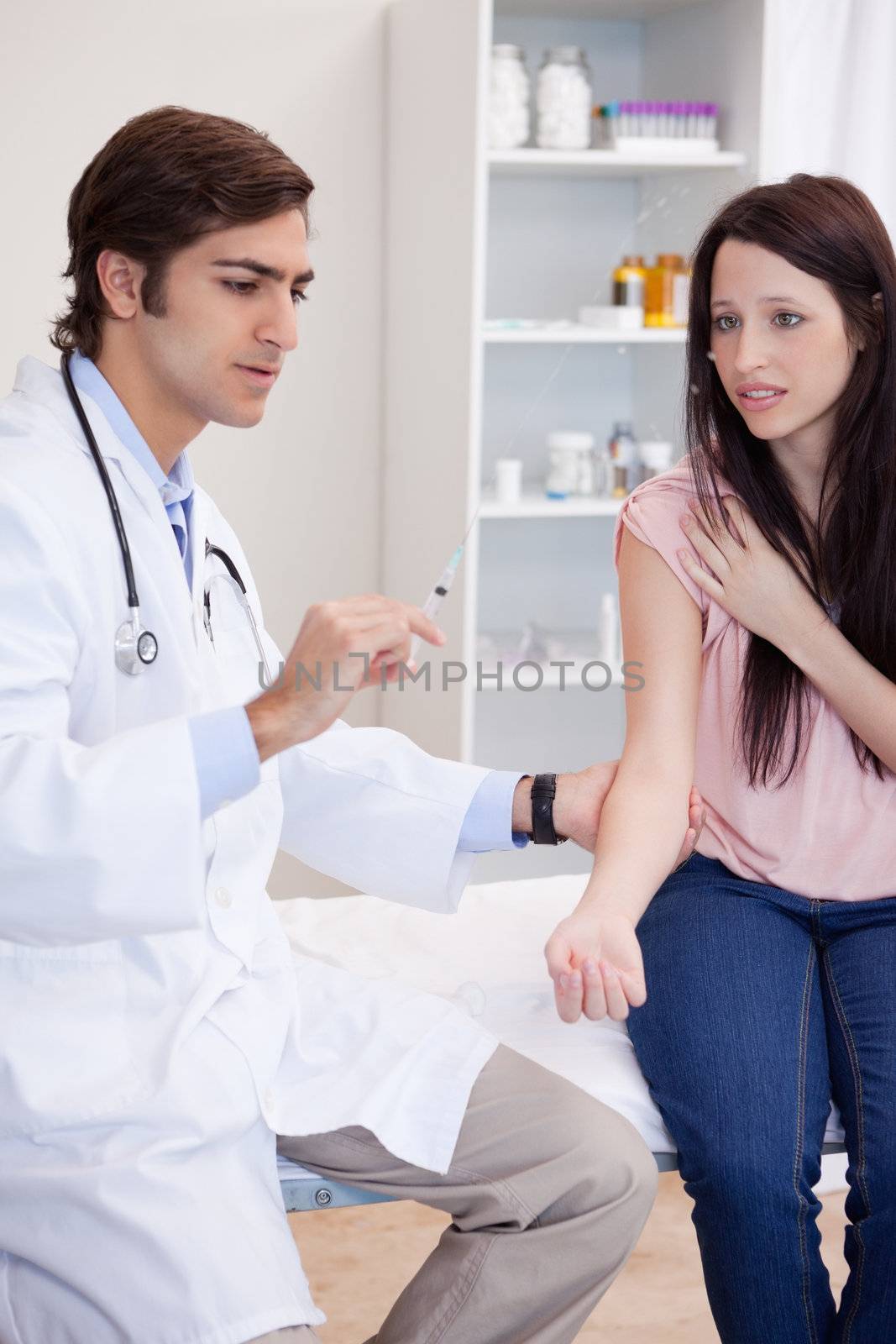 Male doctor about to give an injection to patient