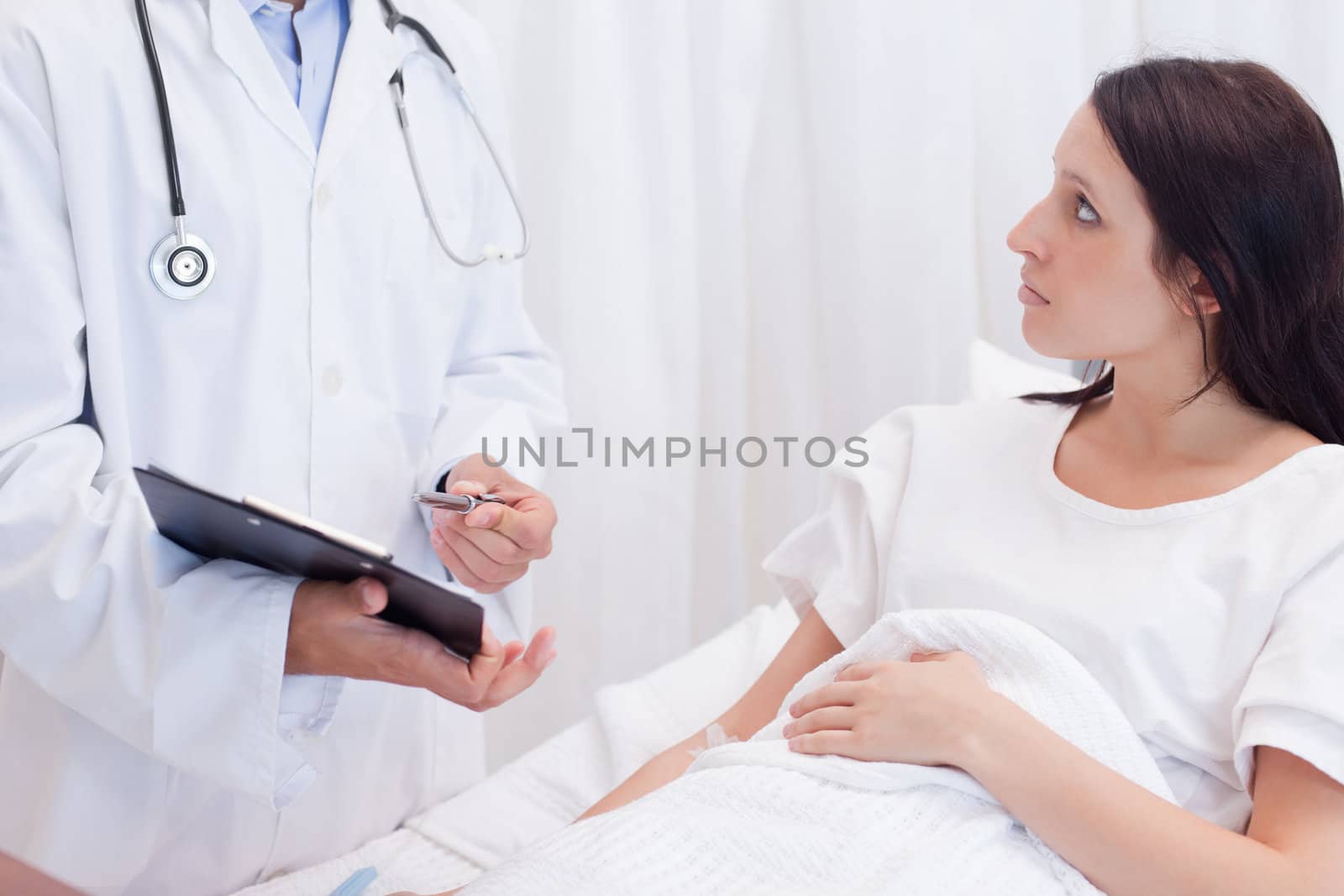 Young female patient getting examination results explained