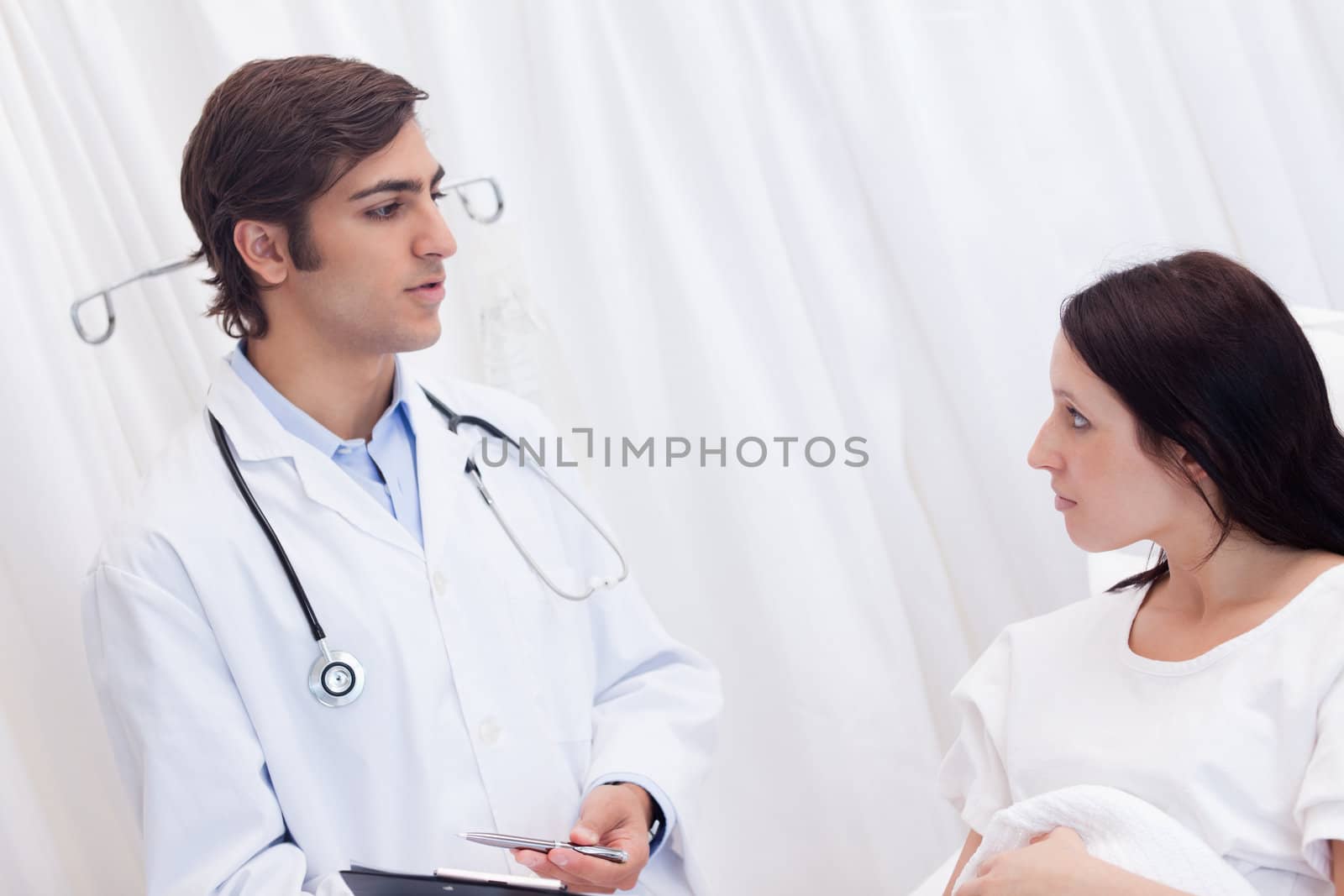 Female patient getting examination results explained by doctor