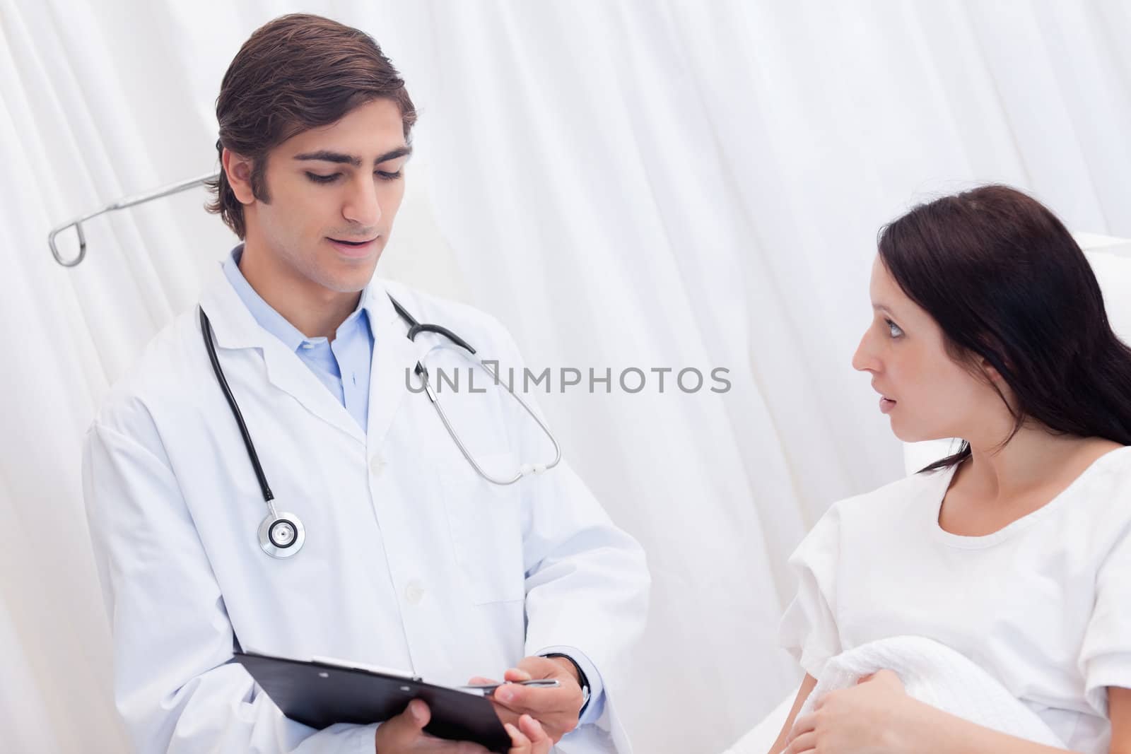 Young doctor and patient talking about examination results