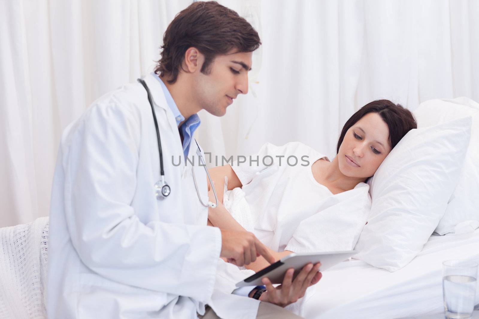 Young male doctor talking to patient